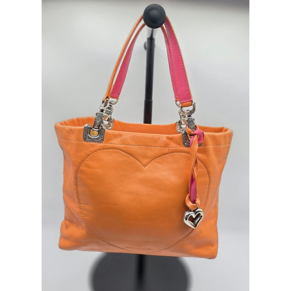 From the Brighton Collectibles Women's Orange Heart Stitch Leather Shoulder Bag
